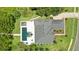 A beautiful aerial view of the home and property shows the sparkling pool and gazebo on a sunny day at 2908 Lee Shore Loop, Orlando, FL 32820