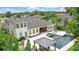 An aerial view shows the beautiful home and sparkling pool with hot tub in a lush residential neighborhood at 2908 Lee Shore Loop, Orlando, FL 32820