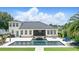 An aerial view of a backyard featuring a sparkling pool with water feature, an outdoor dining area, and manicured lawn space at 2908 Lee Shore Loop, Orlando, FL 32820
