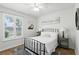 Cozy bedroom with wood floors, a metal bed frame, and natural light from a window with shutters at 2908 Lee Shore Loop, Orlando, FL 32820
