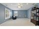 Living room with carpet floors, a blue accent wall and a ceiling fan at 2908 Lee Shore Loop, Orlando, FL 32820