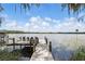 Relaxing lake view from a wooden dock, featuring comfortable seating and serene water at 2908 Lee Shore Loop, Orlando, FL 32820