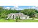 A beautiful house with a neatly manicured lawn, shrubs, and lush trees at 2908 Lee Shore Loop, Orlando, FL 32820