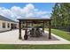 A covered outdoor dining area with a dining table and chairs, ideal for entertaining guests or enjoying a meal at 2908 Lee Shore Loop, Orlando, FL 32820