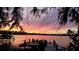 Breathtaking lake sunset scene with a private dock and boats, showcasing the beauty of waterfront living at 2908 Lee Shore Loop, Orlando, FL 32820