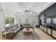 Open living room boasts a large sectional sofa, a decorative ceiling fan and easy access to the outdoors at 2908 Lee Shore Loop, Orlando, FL 32820