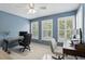 Bright home office with dual workstations, natural light from three windows, and calming blue walls at 2908 Lee Shore Loop, Orlando, FL 32820