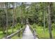A tranquil wooden walkway invites you on a journey through the peaceful and shaded forest at 2908 Lee Shore Loop, Orlando, FL 32820