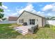 Backyard featuring a sliding glass door, patio, and a decorative concrete bench at 2913 Wilshire Rd, Clermont, FL 34714