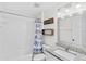 Bright bathroom with granite vanity and a shower-tub combo, stylishly decorated at 2913 Wilshire Rd, Clermont, FL 34714