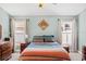 Comfortable bedroom features a ceiling fan, natural light, and pleasing color scheme at 2913 Wilshire Rd, Clermont, FL 34714