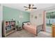 bedroom featuring neutral carpet, bright accent wall, and built in bookshelf at 2913 Wilshire Rd, Clermont, FL 34714