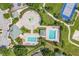 An aerial shot highlights community pools, splash pad, cabana and surrounding manicured landscapes at 2913 Wilshire Rd, Clermont, FL 34714