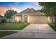 Charming single-Gathering home featuring a well-manicured lawn and a two-car garage at 2913 Wilshire Rd, Clermont, FL 34714