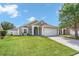 Charming single-Gathering home featuring a well-manicured lawn and a two-car garage at 2913 Wilshire Rd, Clermont, FL 34714