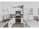Modern kitchen featuring white cabinets, granite countertops, and stainless steel appliances at 2913 Wilshire Rd, Clermont, FL 34714