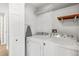 Efficient laundry room featuring washer and dryer, shelving, and storage space at 2913 Wilshire Rd, Clermont, FL 34714