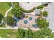 Aerial view of a community playground with colorful play structures, surrounded by mature trees and green spaces at 2913 Wilshire Rd, Clermont, FL 34714