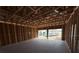 Spacious garage featuring unfinished walls, concrete flooring and an opening to the homes exterior at 30124 Misty Pines Road, Mount Dora, FL 32757