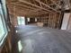 An open-concept home under construction, with framed walls and natural light streaming through the windows at 30124 Misty Pines Road, Mount Dora, FL 32757
