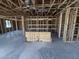 Interior framing reveals an open space, showcasing unfinished concrete floors and exposed utilities at 30124 Misty Pines Road, Mount Dora, FL 32757