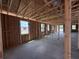 A spacious living room with exposed framing and windows, ready for customization at 30124 Misty Pines Road, Mount Dora, FL 32757