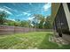 Large backyard with a wood fence and a screened in porch for outdoor enjoyment at 3149 Quail Dr, Deltona, FL 32738