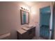 Bathroom featuring modern vanity with vessel sink, decorative mirror, and updated lighting at 3149 Quail Dr, Deltona, FL 32738