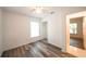Cozy bedroom with wood-look floors, closet and a view to outside at 3149 Quail Dr, Deltona, FL 32738