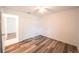 Bright bedroom with wood-look floors, ceiling fan, and a closet at 3149 Quail Dr, Deltona, FL 32738