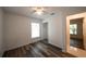 Bedroom featuring wood floors, a window, and access to the bathroom at 3149 Quail Dr, Deltona, FL 32738