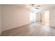 A bright bedroom featuring plank flooring, a ceiling fan, a window and mirrored closet doors at 3149 Quail Dr, Deltona, FL 32738