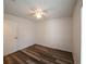 Bedroom features wood floors, a ceiling fan, and a door for access at 3149 Quail Dr, Deltona, FL 32738