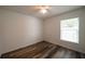 Bedroom featuring wood floors, a window, and a ceiling fan at 3149 Quail Dr, Deltona, FL 32738