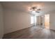 Bright bedroom featuring wood floors, a ceiling fan, and a mirrored closet at 3149 Quail Dr, Deltona, FL 32738