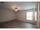Bedroom featuring light colored wood floors, a ceiling fan, and a window at 3149 Quail Dr, Deltona, FL 32738