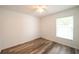 Clean bedroom with wood-look floors and natural light from the window at 3149 Quail Dr, Deltona, FL 32738