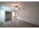 Bright bedroom features wood-look floors, a ceiling fan, and an organized closet space at 3149 Quail Dr, Deltona, FL 32738