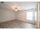A bright bedroom featuring neutral colors, plank flooring, a ceiling fan and mirrored closet doors at 3149 Quail Dr, Deltona, FL 32738