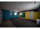 The garage is painted in yellow and blue with gray carpeting and a wall-sized mirror at 3149 Quail Dr, Deltona, FL 32738