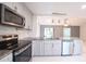 An updated kitchen featuring stainless steel appliances and a view to the living room at 3149 Quail Dr, Deltona, FL 32738