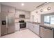 Updated kitchen featuring stainless steel appliances and granite countertops, and gray cabinets at 3149 Quail Dr, Deltona, FL 32738
