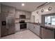 Updated kitchen with granite countertops, stainless steel appliances and tile flooring at 3149 Quail Dr, Deltona, FL 32738