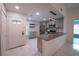 Remodeled kitchen featuring stainless steel appliances, granite counters, tile floors, and natural light at 3149 Quail Dr, Deltona, FL 32738