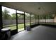 A screened-in porch provides a relaxing outdoor space with views of the backyard at 3149 Quail Dr, Deltona, FL 32738