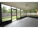 Spacious screened porch with view of the backyard and wooden fence at 3149 Quail Dr, Deltona, FL 32738