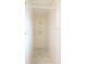 This bathroom features an all white shower with white tile and a marble patterned shower floor at 3149 Quail Dr, Deltona, FL 32738