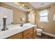 Well-lit bathroom with a white countertop, wooden cabinets, and decorative fixtures above the mirror at 3201 Oaklea Dr, Deland, FL 32720