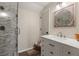 Bathroom showcasing a glass-enclosed shower, white vanity, and decorative mirror at 3201 Oaklea Dr, Deland, FL 32720
