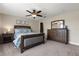 Comfortable bedroom with a ceiling fan, carpeted floor, and dark wood furniture at 3201 Oaklea Dr, Deland, FL 32720